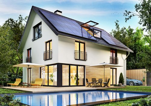 Country house with solar panels on the roof and a terrace and swimming pool.